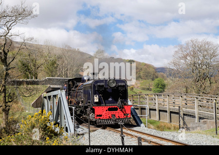 Welsh Highland Railway steam train crossing Afon Glaslyn River bridge in Aberglaslyn Pass Beddgelert Gwynedd North Wales UK Britain Stock Photo