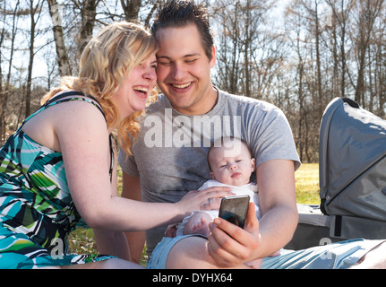 Young family is taking a selfie picture with their smartphone Stock Photo