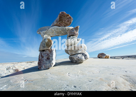 Canada, Nunavut Territory, Inukshuk rock sculpture on Marble Island along Hudson Bay Stock Photo