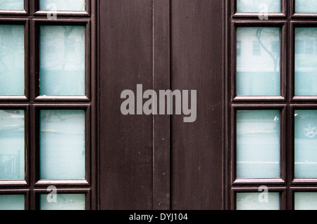 Black Lacquered Front Door Fram with Glass Panes and Reflections, Closed. Stock Photo
