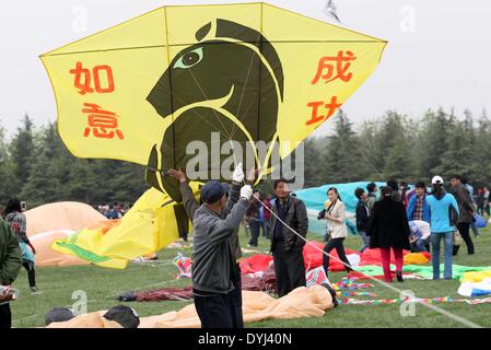 Weifang, China's Shandong Province. 19th Apr, 2014. A participant flies a kite during the 31st Weifang International Kite Festival in Weifang, east China's Shandong Province, April 19, 2014. © Zhang Chi/Xinhua/Alamy Live News Stock Photo
