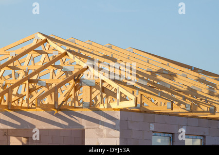 New residential construction home framing over blue sky Stock Photo