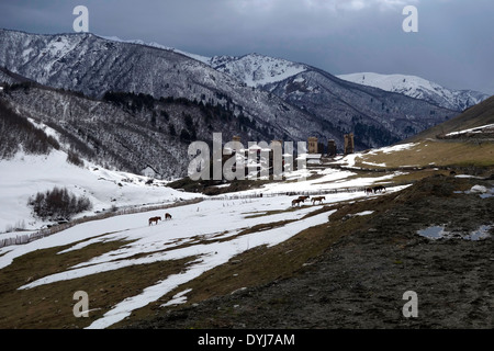 Scenic view of snowy peaks and the village of Ushguli one of the highest continuously inhabited settlements in Europe located at the head of the Enguri gorge in Svaneti, recognized as the Upper Svaneti UNESCO World Heritage Site in the Republic of Georgia Stock Photo