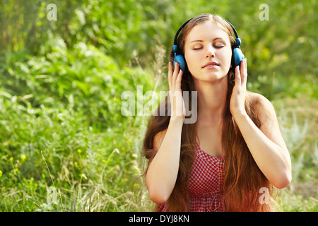 Woman with Headphones Outdoors Stock Photo