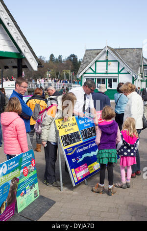 Lake Windermere, Cumbria, UK. 19th April 2014. Tourists making the most of  bright sunshine  Lake cruise information guide helping tourists Credit:  Gordon Shoosmith/Alamy Live News Stock Photo