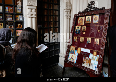 Orthodox devotees praying at the entrance to Kashveti Church of St. George in Tbilisi capital of the republic of Georgia Stock Photo
