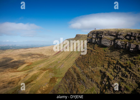 Female hiker on Carmarthen Fans - Bannau Sir Gaer with Picws Du in distance, Black Mountain, Brecon Beacons national park, Wales Stock Photo