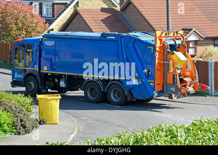 Council dustcart in residential street collecting household rubbish Stock Photo