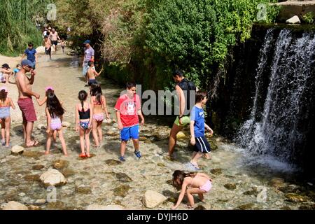 Jericho, Wadi Kelt. 19th Apr, 2014. Tourists enjoy the spring of Ein Fara, the upper spring of Wadi Kelt, in the Nahal Prat Nature Reserve near the West Bank city of Jericho on April 19, 2014. Wadi Kelt is a valley running west to east across the Judean desert in the West Bank, originating near Jerusalem and terminating near Jericho. © Mamoun Wazwaz/Xinhua/Alamy Live News Stock Photo
