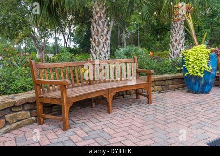 Garden scene with wooden bench Stock Photo