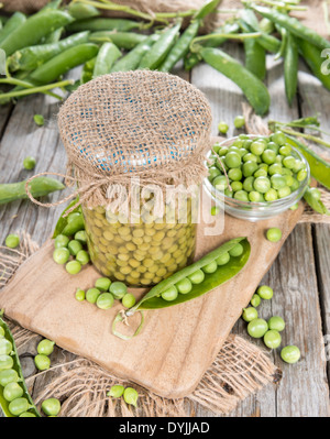 Small portion of canned Peas with some fresh pods Stock Photo