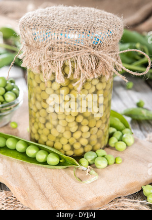 Small portion of canned Peas with some fresh pods Stock Photo