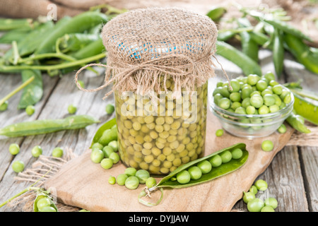 Small portion of canned Peas with some fresh pods Stock Photo