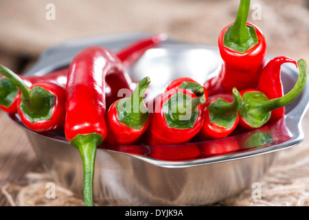 Small bowl with red Chillies on wooden background Stock Photo