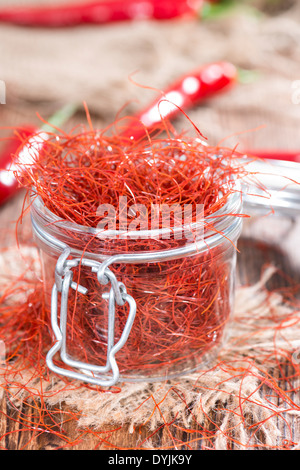 Small portion of dried Chilli Strings on wooden background Stock Photo