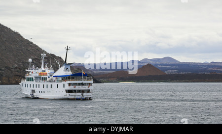 The cruise ship La Pinta anchored off Bartolome Island in the Galapagos Islands with Santiago Island in the distance. Stock Photo