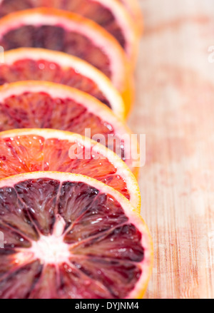 Fresh Blood Oranges on wooden background Stock Photo
