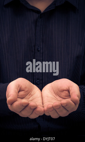 The man's hands in a gesture of holding something or ask for help Stock Photo