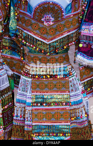 Flower Hmong dresses for sale in market, Bac Ha, Sapa (Sa Pa), North Vietnam Stock Photo