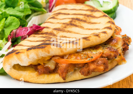 A barbecue pulled pork flatbread panini and salad - studio shot Stock Photo