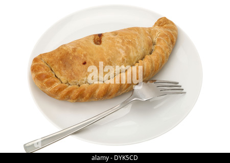 Traditional Cornish pasty served on a white plate with a fork - white background Stock Photo