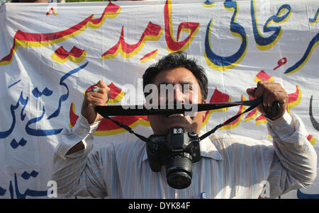 LAHORE,PAKISTAN-APRIL 20: Pakistani Journalists chant slogans against dastardly attack on Private T.V Channel senior anchorperson Hamid Mir during protest demonstration arranged by Federal Union of Journalists at Lahore on April 20, 2014. (Photo by Rana Sajid Hussain/Pacific Press) Stock Photo