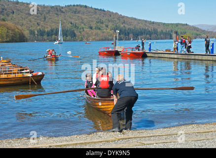 Visitors hiring a dinghy on Lake Windermere, Bowness Bay, Lake District National Park, Cumbria, England UK Stock Photo