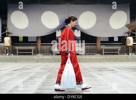 Tokyo, Japan. 21st Apr, 2014. A woman walks at Yasukuni Shrine in Tokyo, Japan, April 21, 2014. The shrine's annual spring festival is held for 3 days from Monday. © Stinger/Xinhua/Alamy Live News Stock Photo