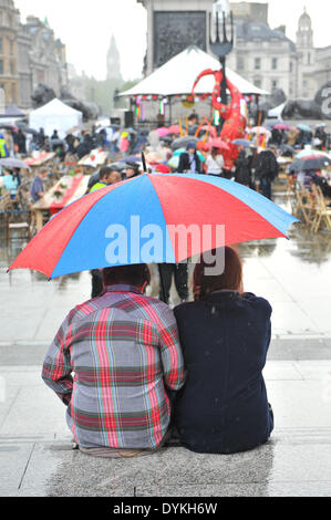 Trafalgar Square, London, UK. 21st April 2014. A sudden downpour of rain dampens the festivities for the crowd in Trafalgar Square on the annual Feast Day. Credit:  Matthew Chattle/Alamy Live News Stock Photo