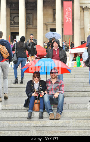 Trafalgar Square, London, UK. 21st April 2014. A sudden downpour of rain dampens the festivities for the crowd in Trafalgar Square on the annual Feast Day. Credit:  Matthew Chattle/Alamy Live News Stock Photo