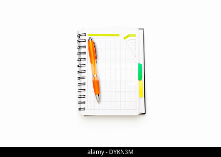 open schedule with ring binder and orange ball pen, isolated on white. Stock Photo