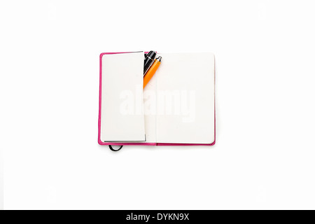 blank open diary with two pens in side pocket, isolated on white. Stock Photo