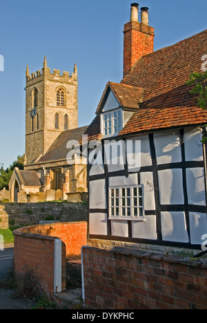 The village church and medieval half timbered black and white cottages in the Warwickshire village of Welford on Avon.