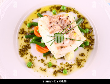 Cod Fillet with green beans, peas, parsley, olive oil, top view Stock Photo