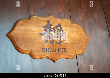 Wooden sign reading 'silence' in English and Chinese Stock Photo