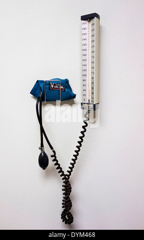 Manual equipment for measuring blood pressure on wall in medical doctor's office.  Cuff and gauge, manometer. Stock Photo