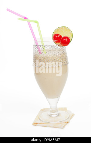 Delicious banana milkshake with cherry and lemon garnish isolated on white background. Healthy summer drinks. Stock Photo