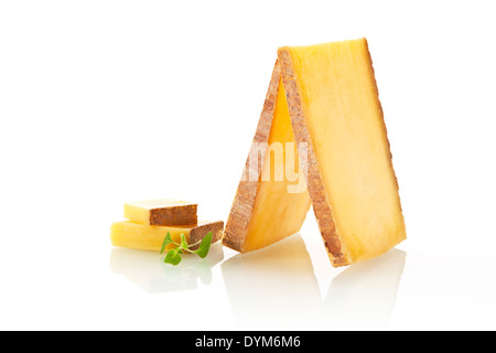 Luxurious cheese slices and pieces arranged on white background. Stock Photo