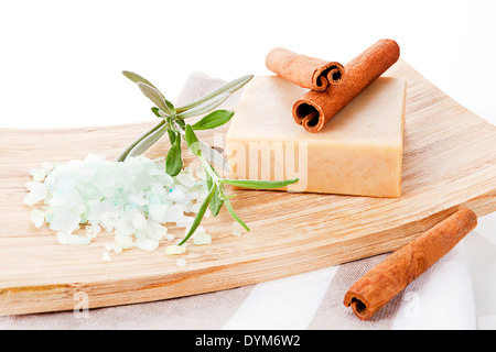 Square cinnamon soap bar and bath salt with cinnamon isolated on brown towel. Stock Photo