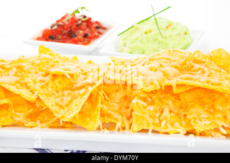 Delicious nachos baked with cheese close up. Stock Photo