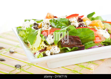 Salad. Fresh mix salad with goat cheese, dried tomatoes and other fresh vegetables. Stock Photo