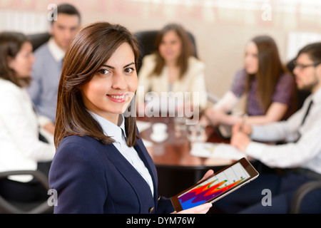 Successful businesswoman at the office leading a group Stock Photo