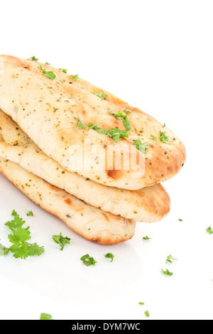 Culinary naan flatbread stack with fresh parsley isolated on white background. Traditional eastern bread eating. Stock Photo
