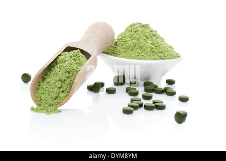 Wheatgrass powder, green chlorella and spirulina pills isolated on white background with reflection. Healthy living. Stock Photo