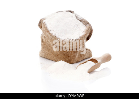 Flour in brown burlap sack isolated on white background. Bread making concept. Stock Photo