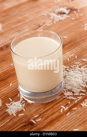 Rice milk on wooden background. Vegan milk drinking. Stock Photo