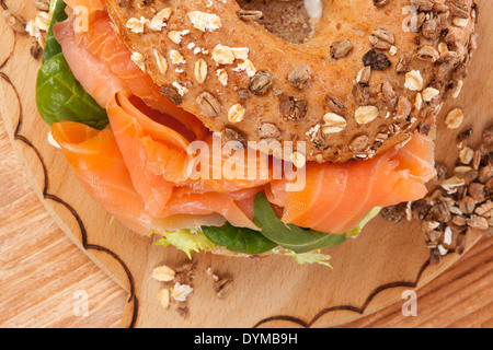 Delicious bagel eating. Fresh baked bagel with smoked salmon top view. American eating. Stock Photo
