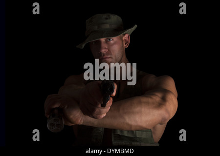 Proud muscular serious officer aiming gun on camera. Crime and security concept. Busted. Stock Photo