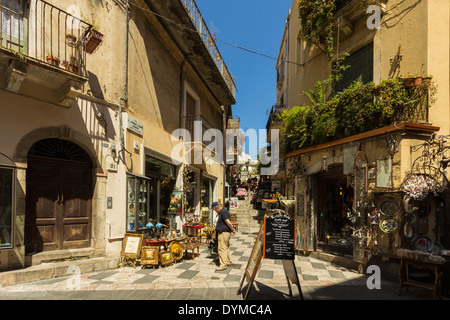 Shops & pub on side street off touristy Corso Umberto in this popular NE tourist town; Taormina, Catania Province, Sicily, Italy Stock Photo