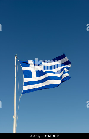 National flag Greece flying high proudly on flag pole against blue sky backdrop Greek flag made up two Stock Photo